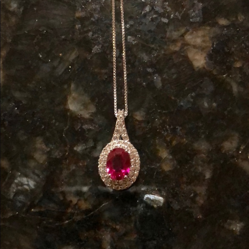 Ruby stone necklace with diamonds all around.